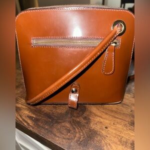 Pratesi Firenze leather crossbody bag with a gold-tone logo plaque.